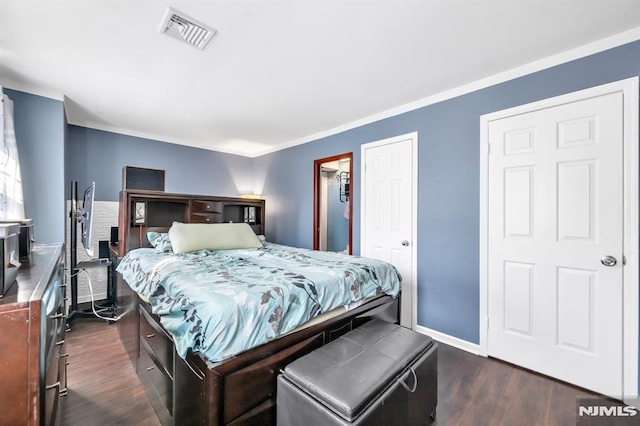 bedroom with dark hardwood / wood-style flooring and crown molding