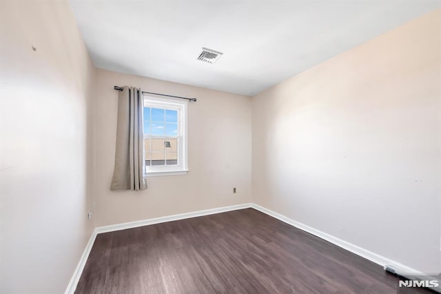 empty room featuring dark wood-type flooring