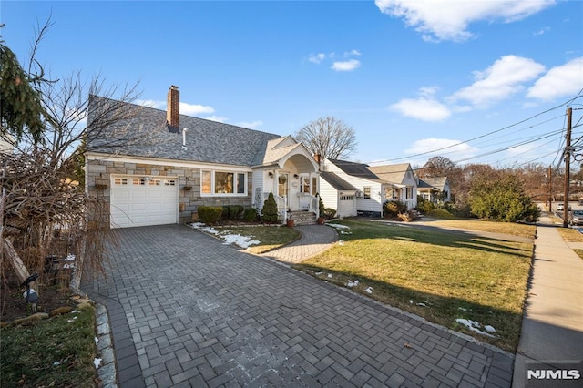 view of front facade with a garage and a front lawn