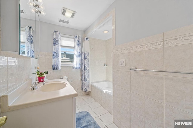 bathroom featuring vanity, tile patterned flooring, tile walls, and shower / tub combo with curtain