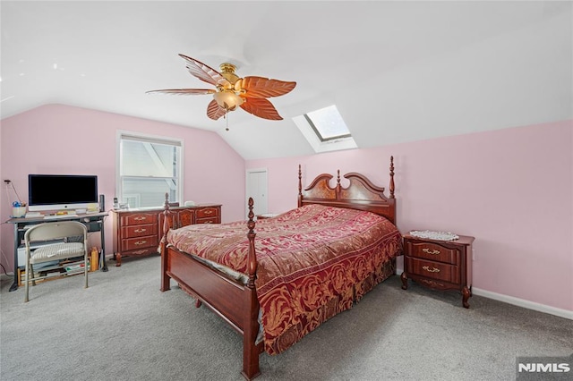 bedroom featuring ceiling fan, lofted ceiling with skylight, and light carpet