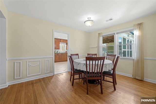 dining room with light hardwood / wood-style flooring