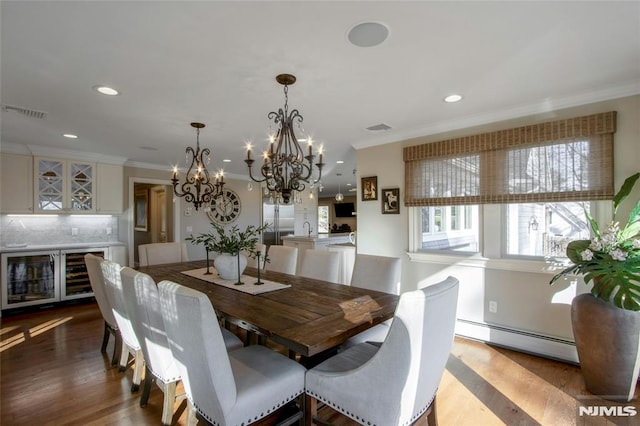 dining space with hardwood / wood-style floors, wine cooler, crown molding, a notable chandelier, and a baseboard heating unit