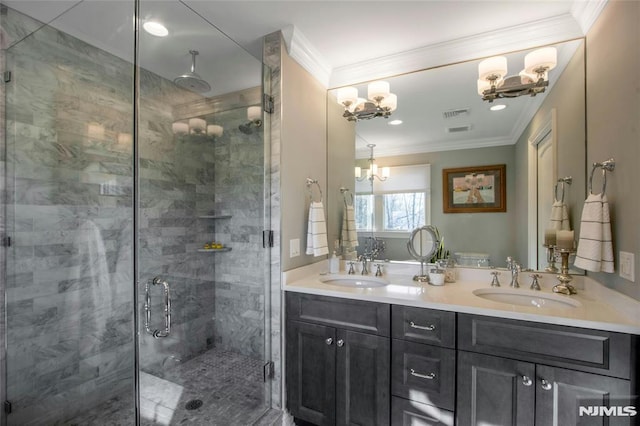 bathroom with an enclosed shower, vanity, an inviting chandelier, and crown molding