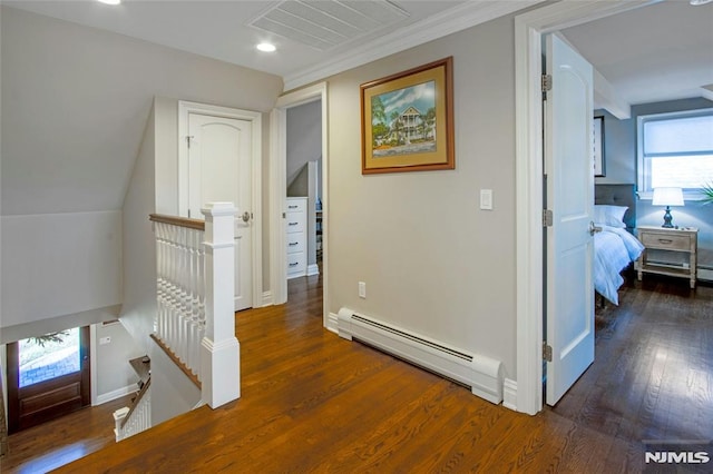 corridor featuring baseboard heating, vaulted ceiling, and dark hardwood / wood-style floors