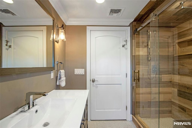 bathroom with ornamental molding, walk in shower, and vanity