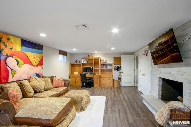 living room featuring a fireplace and wood-type flooring