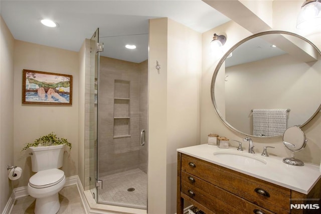 bathroom featuring tile patterned floors, an enclosed shower, vanity, and toilet