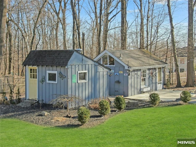 view of outbuilding with a lawn