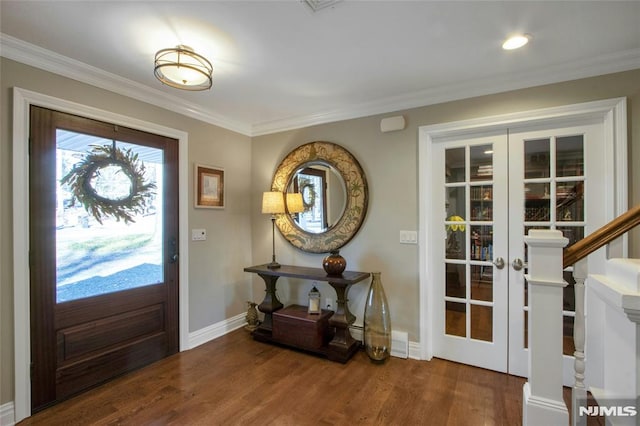 foyer with french doors, dark hardwood / wood-style flooring, and ornamental molding