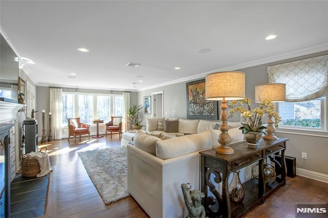 living room featuring dark hardwood / wood-style flooring, plenty of natural light, and crown molding