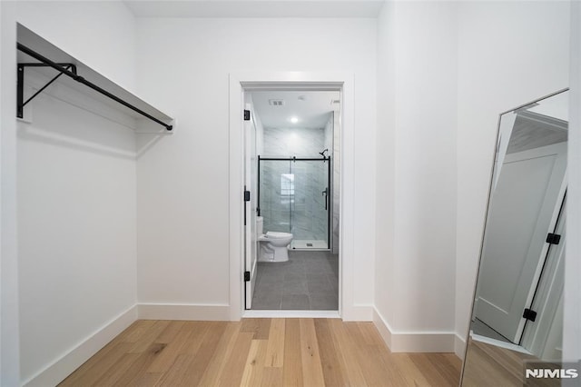 walk in closet featuring light hardwood / wood-style floors