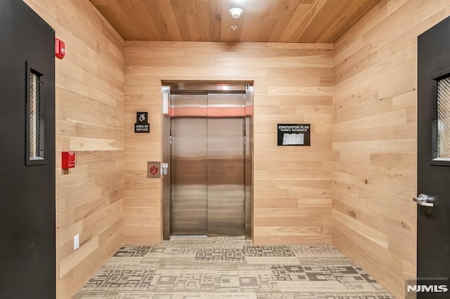 bathroom featuring wooden ceiling, wood walls, and elevator