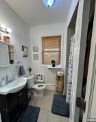 bathroom featuring vanity, tile patterned floors, and toilet