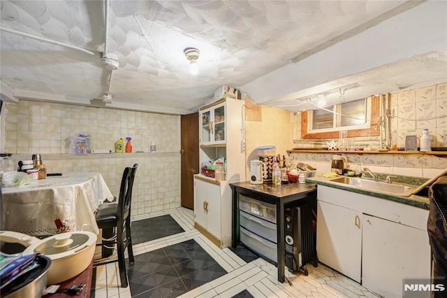 kitchen with sink, white cabinetry, and tasteful backsplash