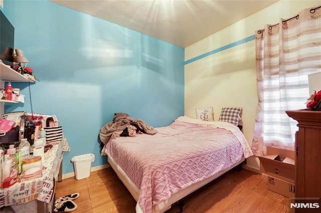 bedroom with hardwood / wood-style flooring