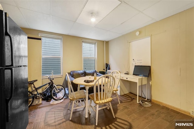 dining area with a drop ceiling