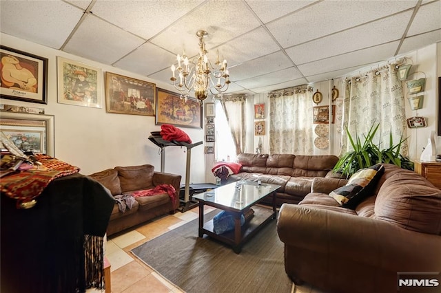 tiled living room with an inviting chandelier and a drop ceiling