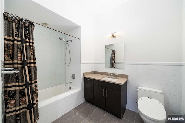 full bathroom featuring vanity, shower / bath combo with shower curtain, tile patterned floors, and toilet