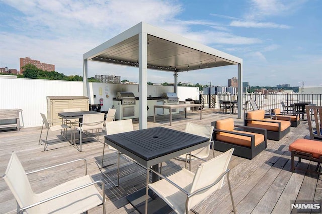 wooden terrace with a grill, an outdoor hangout area, and area for grilling