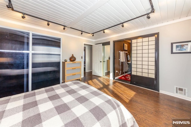 bedroom featuring hardwood / wood-style flooring, track lighting, ornamental molding, and wooden ceiling