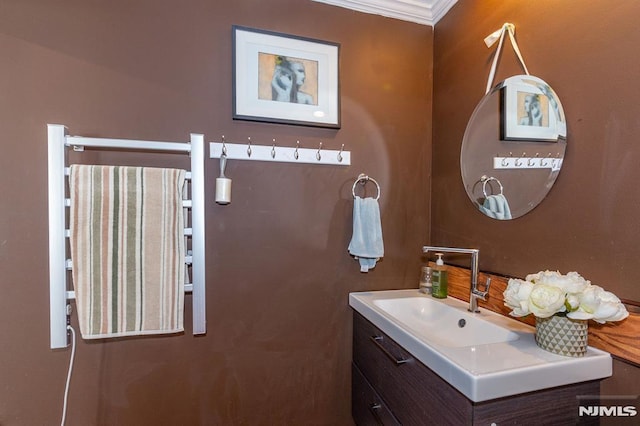 bathroom with ornamental molding and vanity