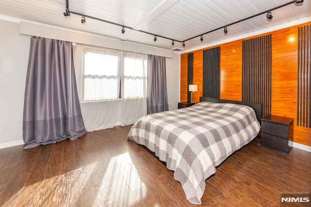 bedroom with wood ceiling, wooden walls, rail lighting, and wood-type flooring