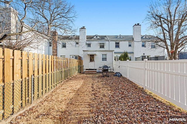 view of yard with entry steps and a fenced backyard