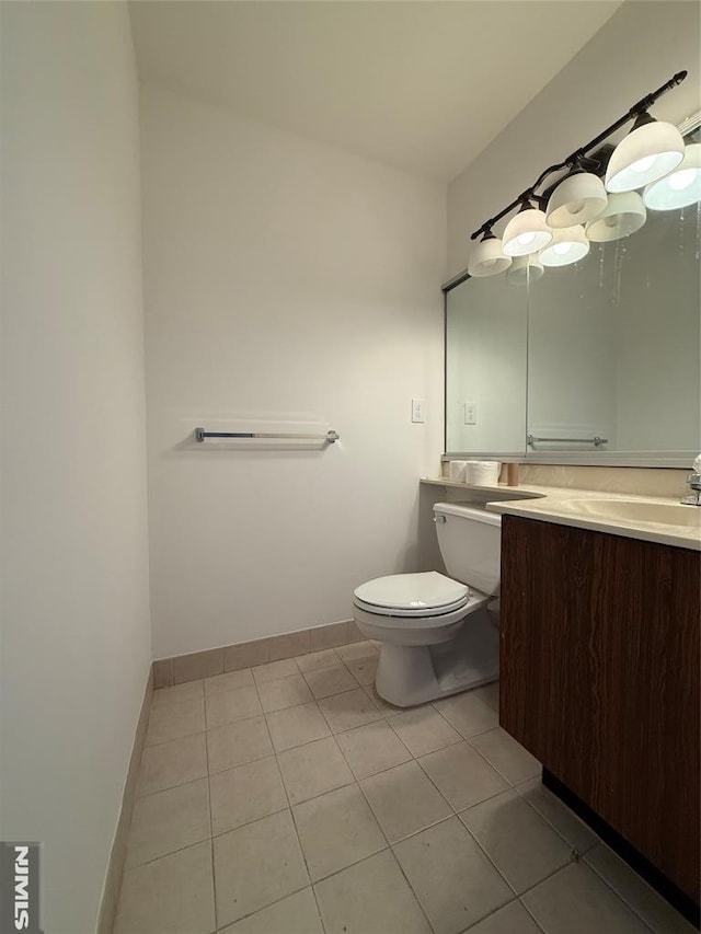 bathroom with vanity, tile patterned floors, and toilet