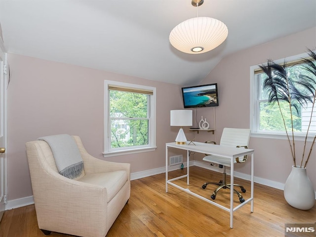 office space featuring hardwood / wood-style floors and lofted ceiling