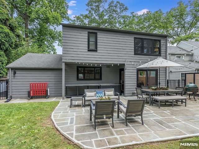 rear view of property with a patio area and an outdoor living space