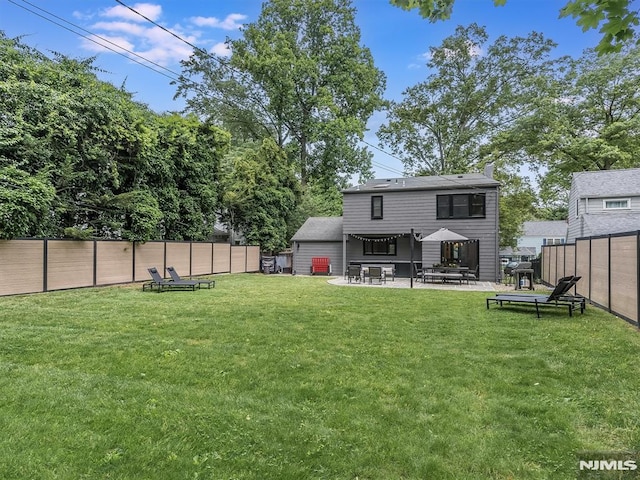 rear view of house featuring a patio area and a lawn