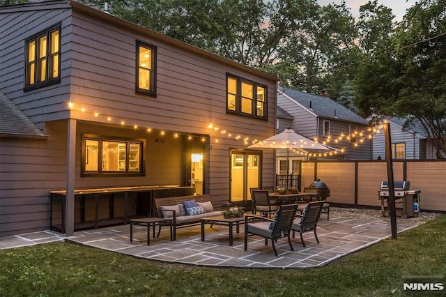 rear view of house with an outdoor hangout area and a patio area