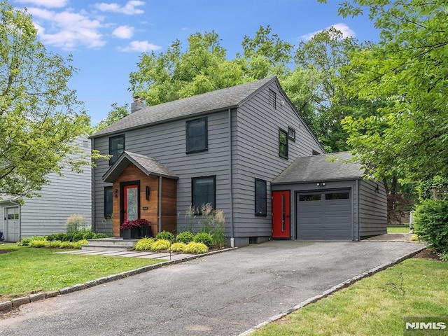 view of front of home featuring a front yard and a garage