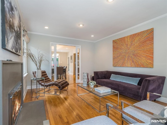 living room with wood-type flooring and crown molding