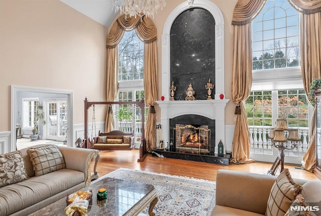 living room featuring a wealth of natural light, a chandelier, and hardwood / wood-style flooring