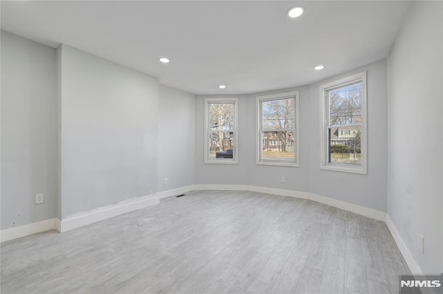 spare room with light hardwood / wood-style floors