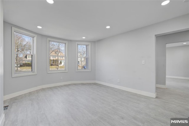 unfurnished room with light hardwood / wood-style flooring