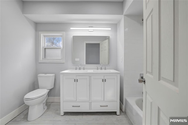 full bathroom featuring toilet, shower / bathtub combination, and vanity