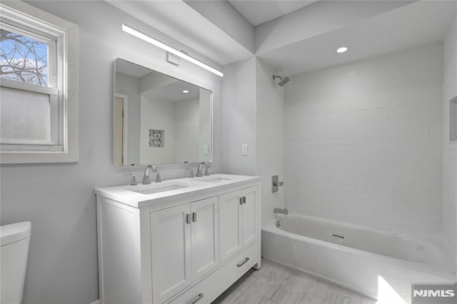 full bathroom with shower / bathtub combination, vanity, and toilet