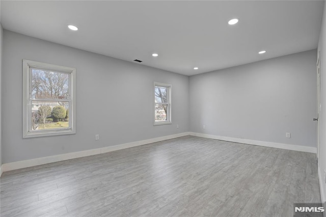 spare room featuring light wood-type flooring