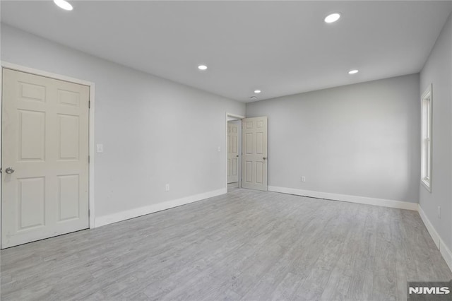 unfurnished room featuring light hardwood / wood-style floors