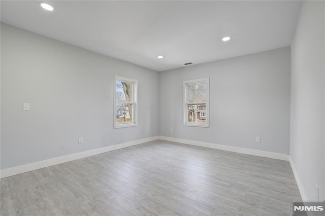 spare room with light hardwood / wood-style flooring