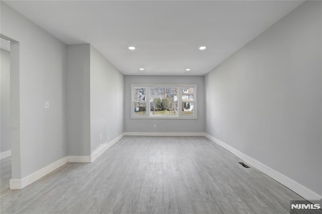 spare room featuring light hardwood / wood-style floors