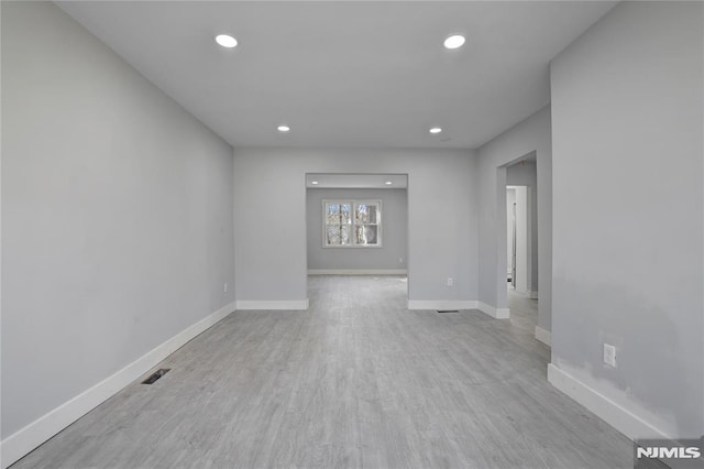 spare room with light wood-type flooring