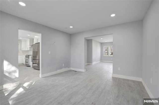 spare room featuring light hardwood / wood-style flooring