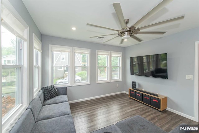 living room with ceiling fan and dark hardwood / wood-style floors