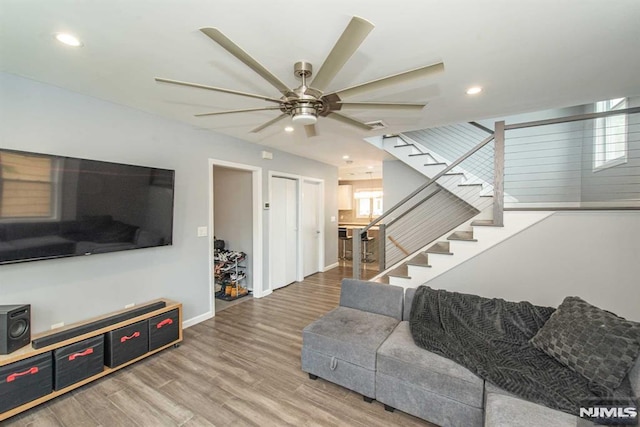 living room with ceiling fan and wood-type flooring