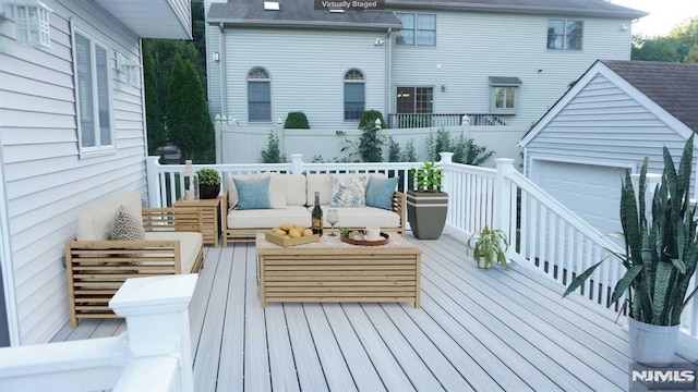 wooden terrace featuring a garage and outdoor lounge area