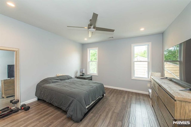 bedroom with ceiling fan and dark hardwood / wood-style flooring